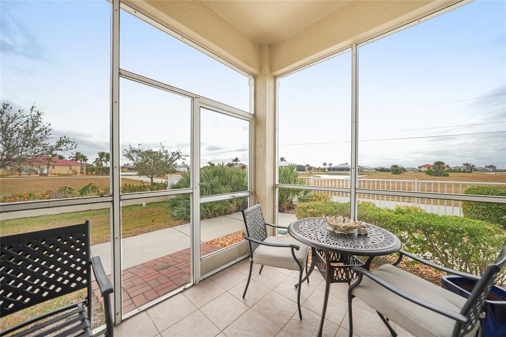 17094 Acapulco Road, Unit 313 Punta Gorda, FL 33955 - Photo 28 of 49 a view of a patio with a table chairs and a table