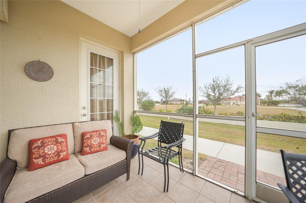 17094 Acapulco Road, Unit 313 Punta Gorda, FL 33955 - Photo 29 of 49 a living room with furniture and a floor to ceiling window