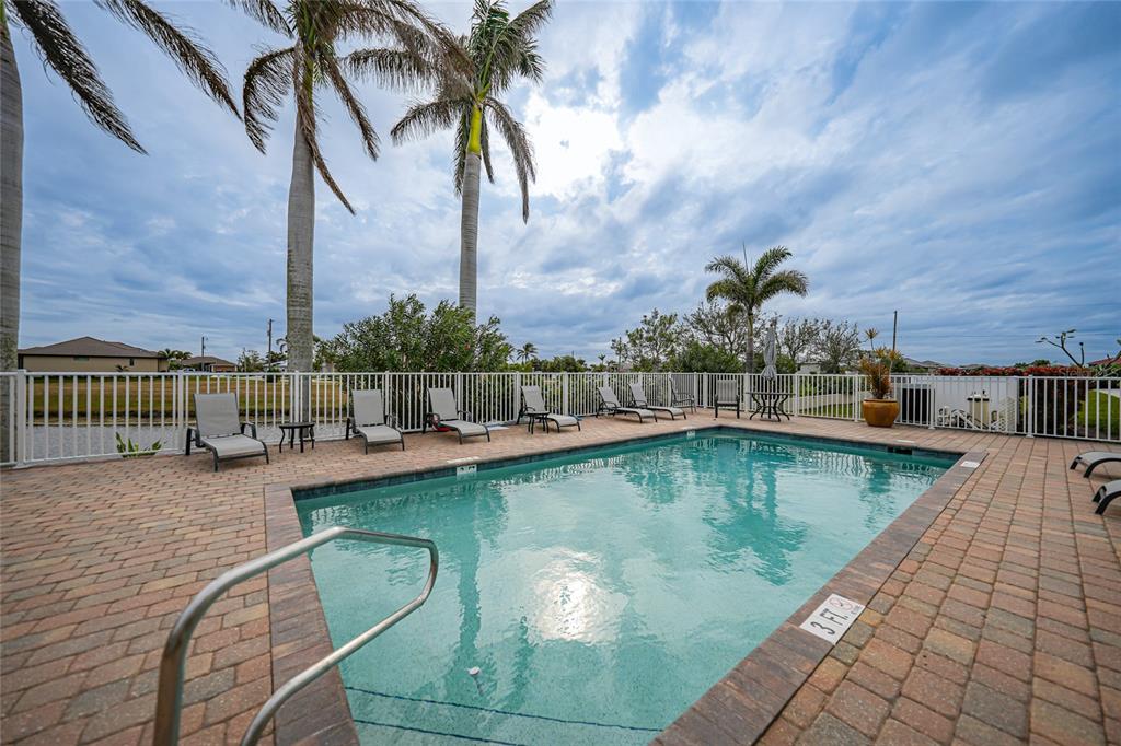 17094 Acapulco Road, Unit 313 Punta Gorda, FL 33955 - Photo 3 of 49 a view of a swimming pool with a lounge chair