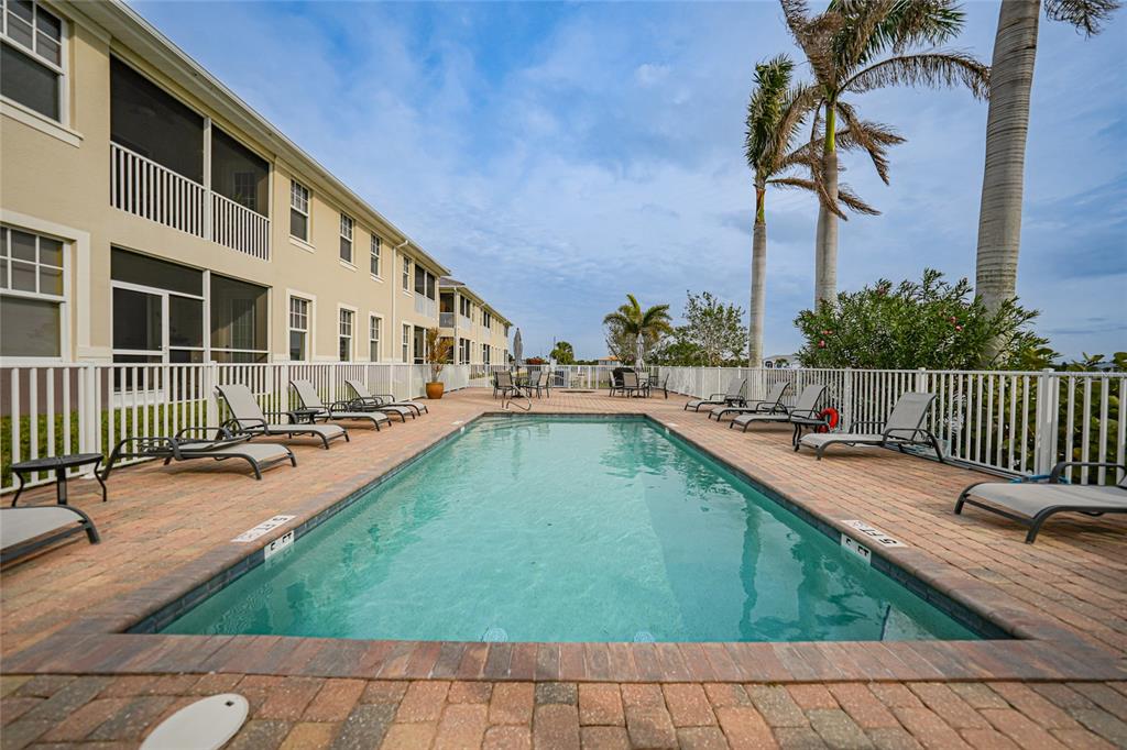 17094 Acapulco Road, Unit 313 Punta Gorda, FL 33955 - Photo 33 of 49 a view of swimming pool with chairs