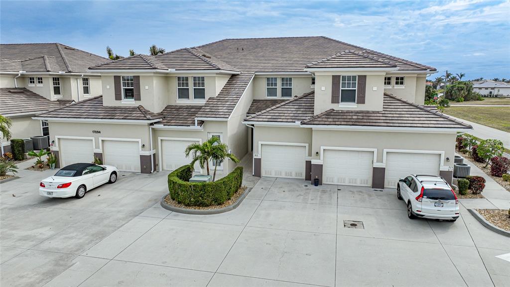 17094 Acapulco Road, Unit 313 Punta Gorda, FL 33955 - Photo 39 of 49 a car parked in front of white house
