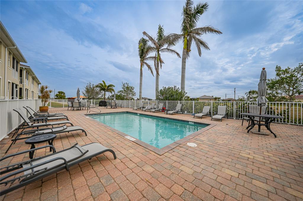 17094 Acapulco Road, Unit 313 Punta Gorda, FL 33955 - Photo 4 of 49 a view of swimming pool with chairs
