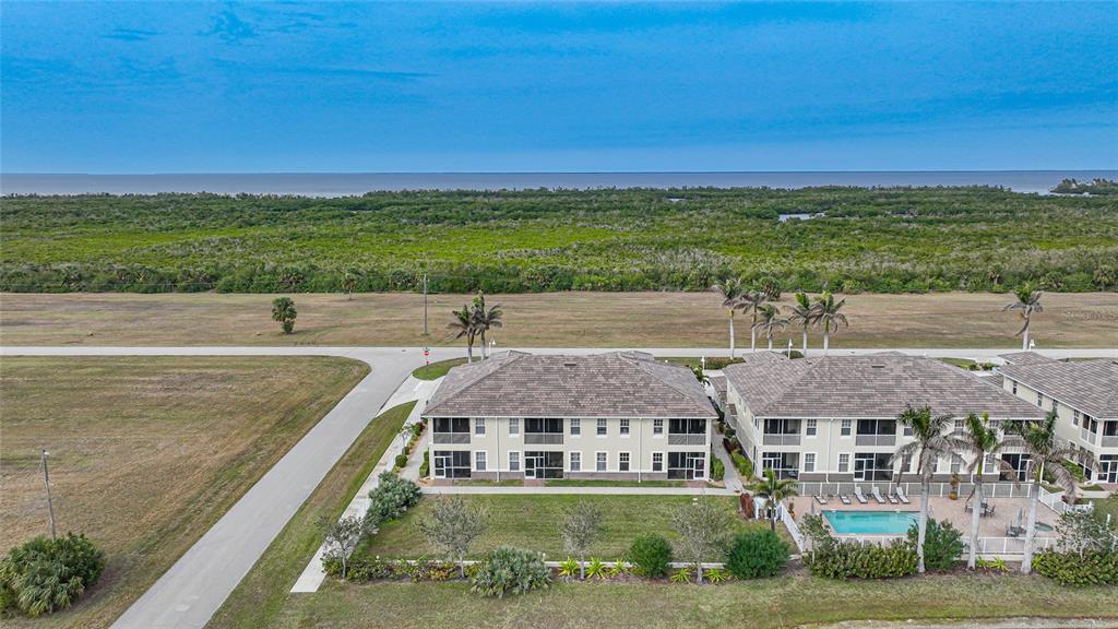 17094 Acapulco Road, Unit 313 Punta Gorda, FL 33955 - Photo 44 of 49 a view of a swimming pool with an outdoor seating and yard