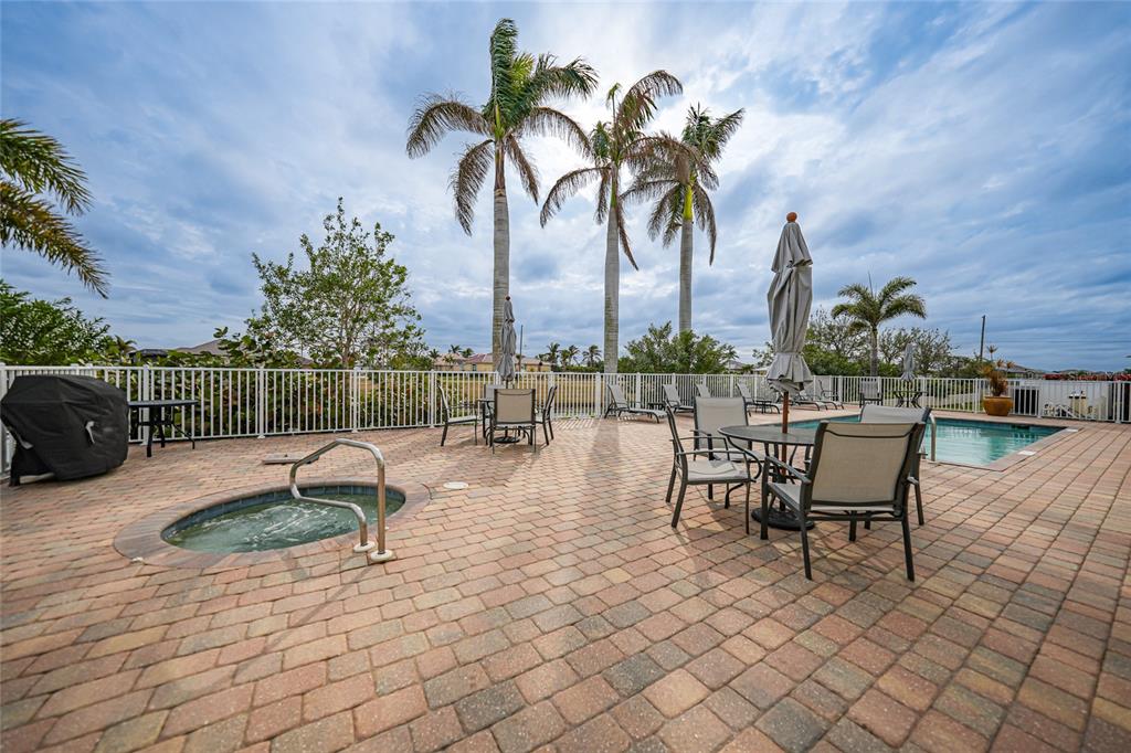 17094 Acapulco Road, Unit 313 Punta Gorda, FL 33955 - Photo 5 of 49 a swimming pool with outdoor seating and yard