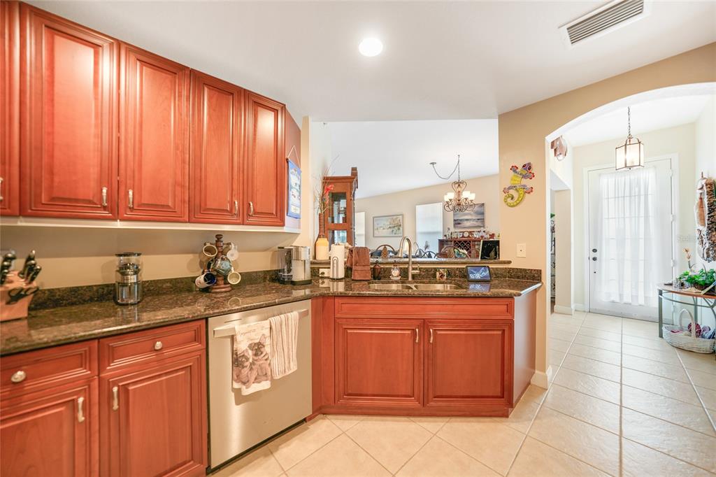 17094 Acapulco Road, Unit 313 Punta Gorda, FL 33955 - Photo 10 of 49 a kitchen with stainless steel appliances granite countertop sink stove and cabinets