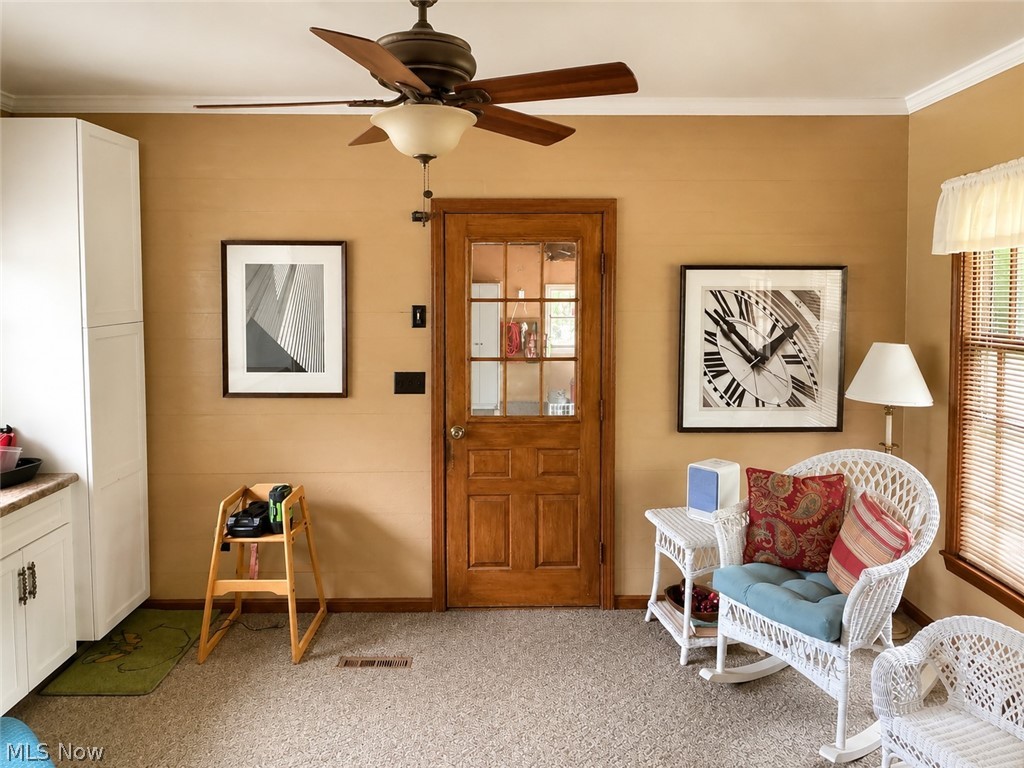 6155 Gibson Road Canfield, OH 44406 - Photo 25 of 43 Room featuring a wood-panel door with glass inserts, textured wall finish, and a ceiling fan with integrated lighting
