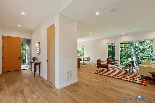 a living room with furniture wooden floor and a table