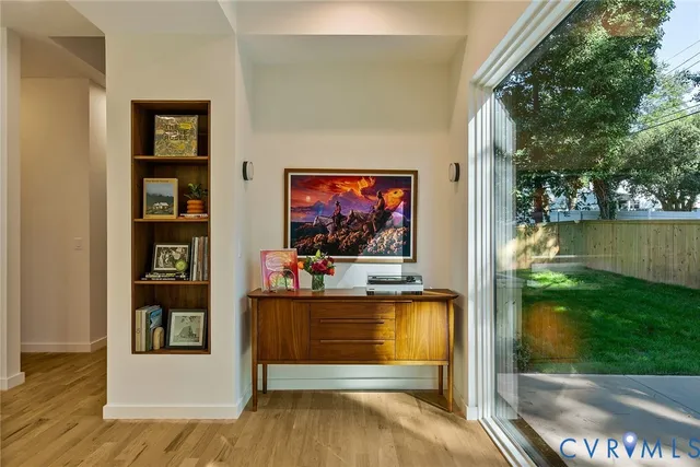 a living room with a flat screen tv and a floor to ceiling window