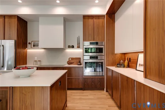a kitchen with stainless steel appliances granite countertop a sink stove and cabinets