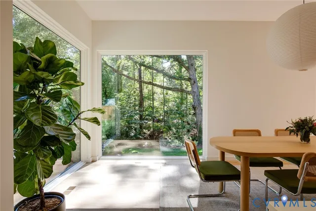 a view of a patio with table and chairs and potted plants