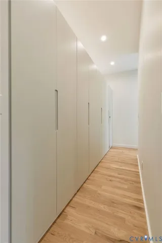 a view of hallway with wooden floor