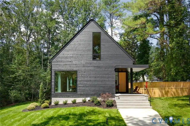 a view of house with outdoor space and sitting area