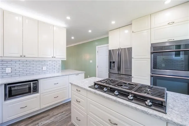 a stove top oven sitting inside of a kitchen
