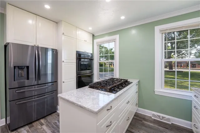 a kitchen with a refrigerator and a sink