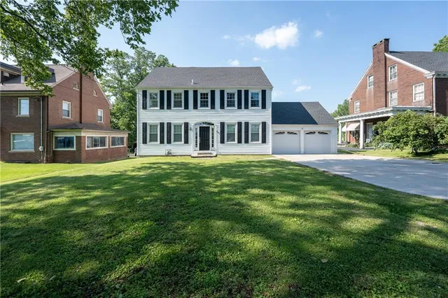 a front view of a building with a garden
