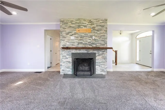 a view of empty room with a fireplace