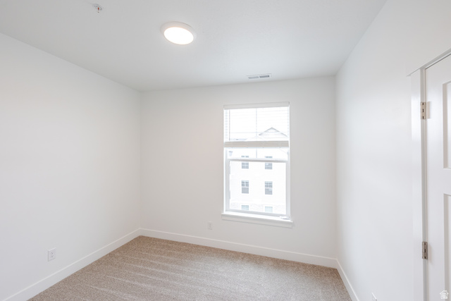 4664 South 680th West, Unit S301 Mapleton, UT 84664 - Photo 6 of 17 Bright room featuring a single window with blinds, neutral carpeting, white walls, and a flush-mount ceiling light