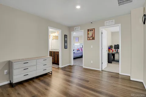 a view of a livingroom with wooden floor and cabinet