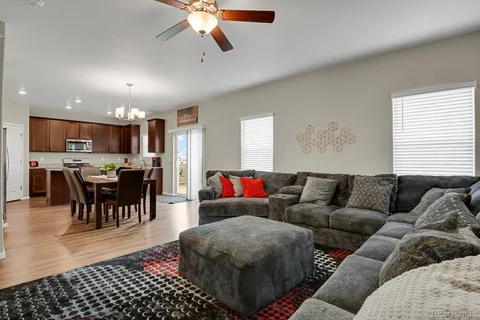 a living room with furniture and a view of kitchen