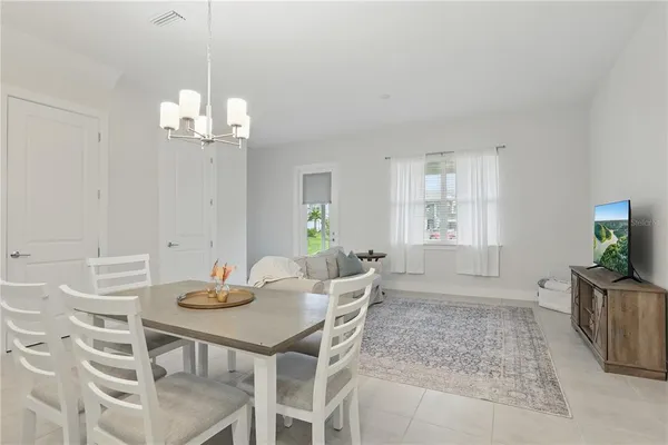 a view of a dining room with furniture wooden floor and chandelier