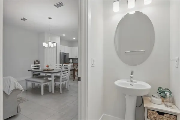 a view of a dining room with furniture and chandelier