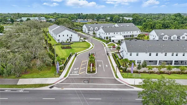 an aerial view of a house with a garden and lake view