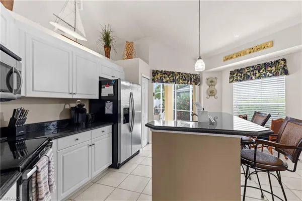 a kitchen with stainless steel appliances kitchen island granite countertop a sink and cabinets