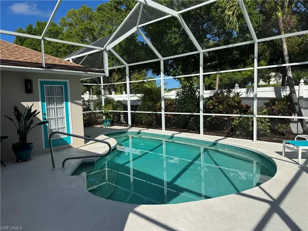 a view of a chairs and table in the backyard