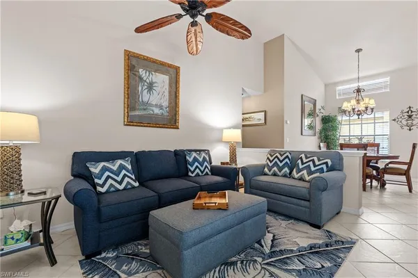 a living room with furniture a rug and a window