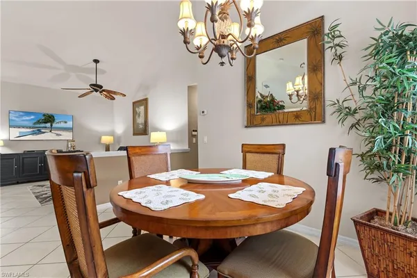 a view of a dining room with furniture and chandelier