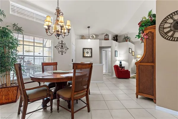 a view of a dining room with furniture and chandelier