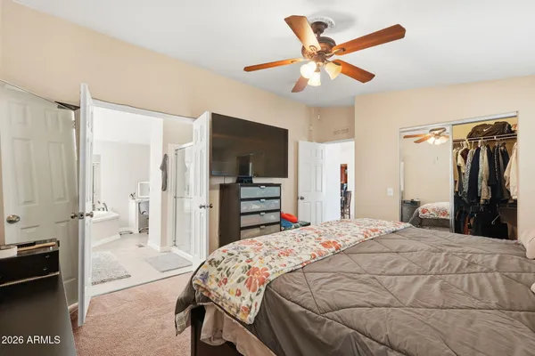 a bed room with a bed and a television