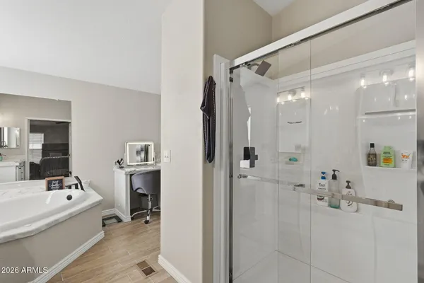 a bathroom with a tub a sink and mirror