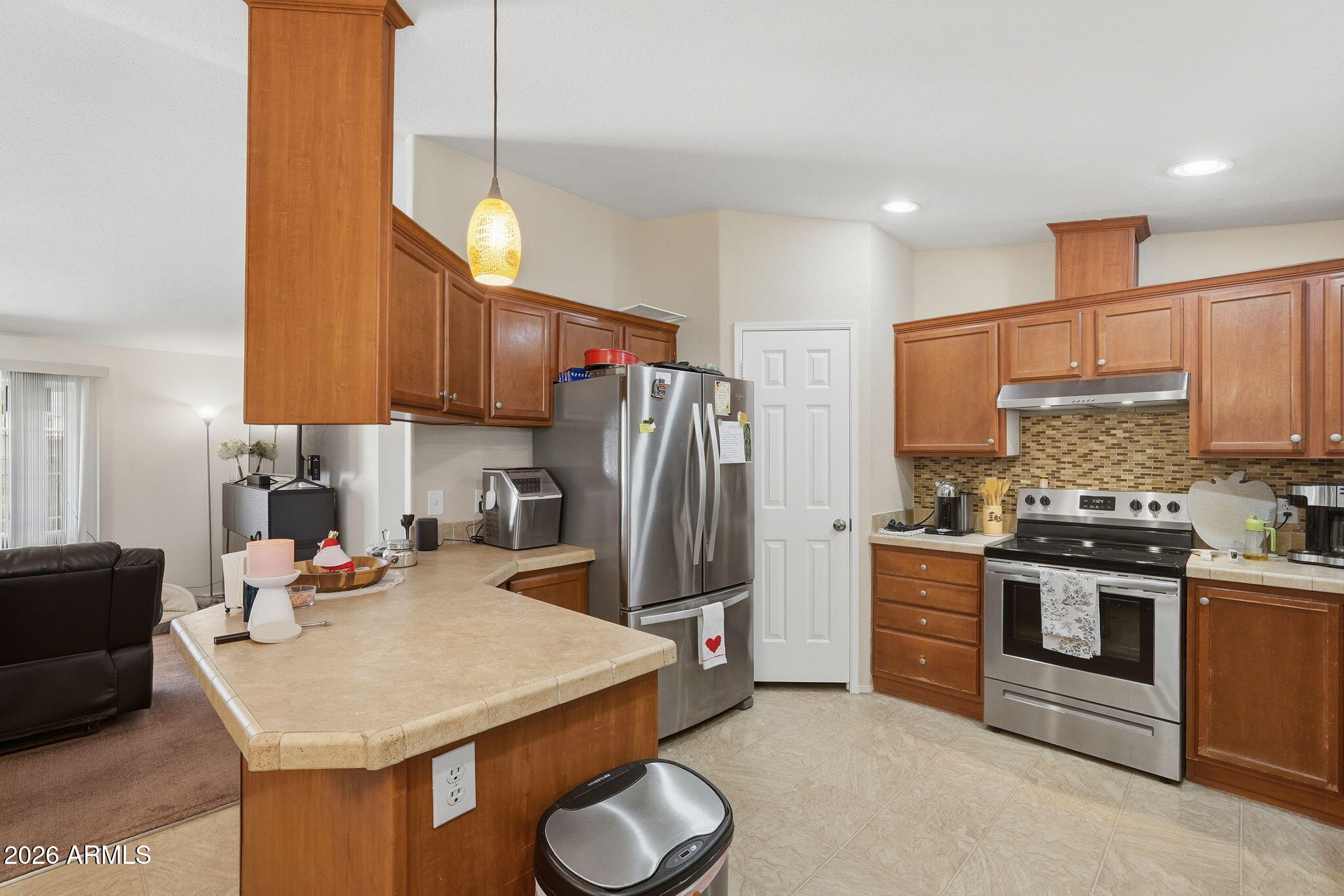 1355 West 4th Avenue Apache Junction, AZ 85120 - Photo 6 of 26 a kitchen with stainless steel appliances granite countertop a sink refrigerator stove and microwave