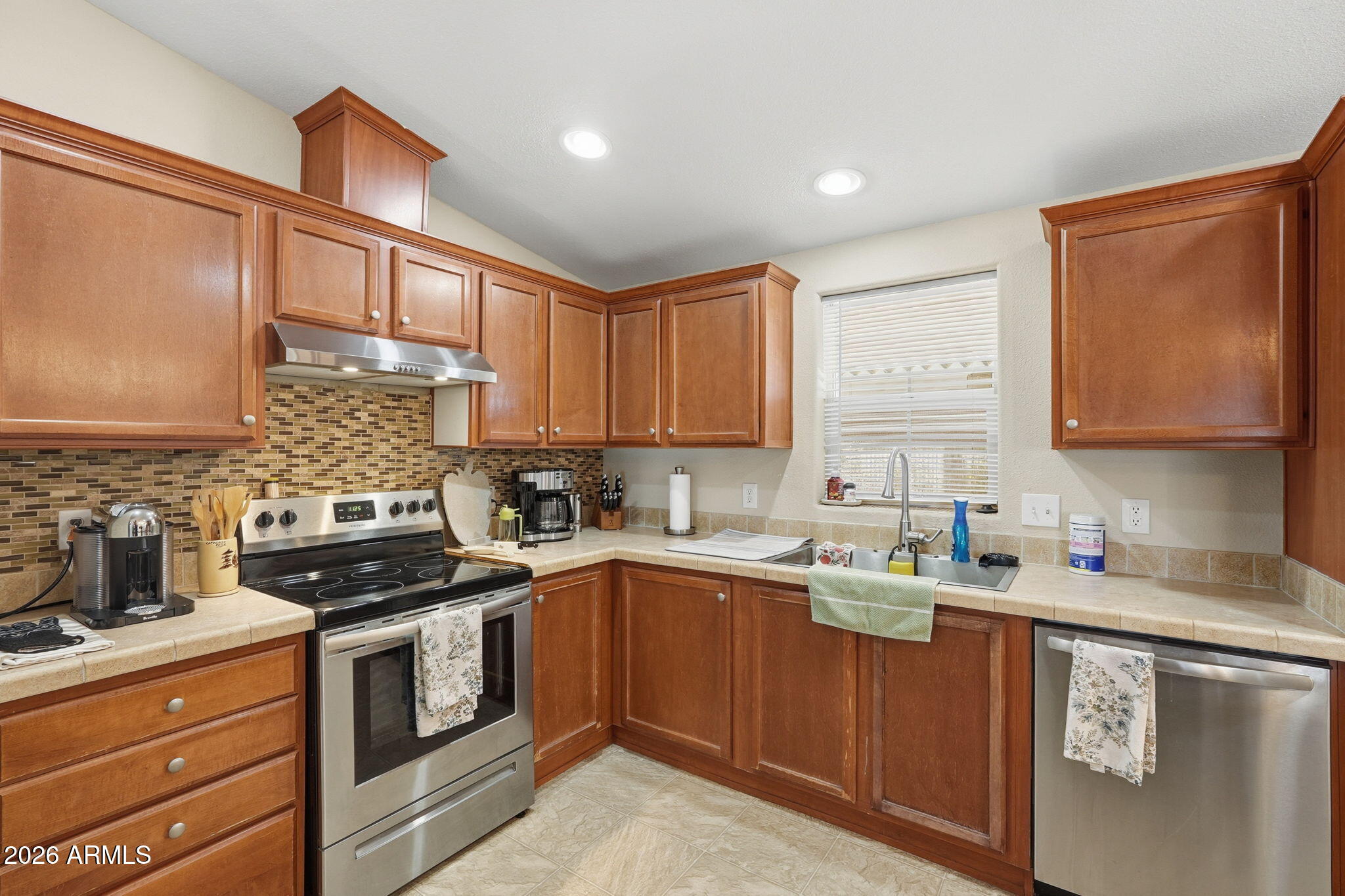 1355 West 4th Avenue Apache Junction, AZ 85120 - Photo 7 of 26 a kitchen with stainless steel appliances a sink stove and cabinets
