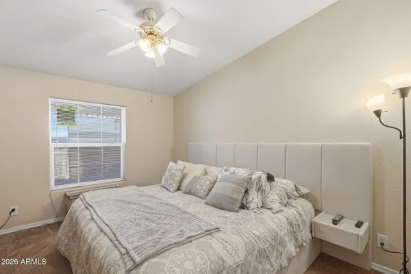 a bedroom with a bed and a window