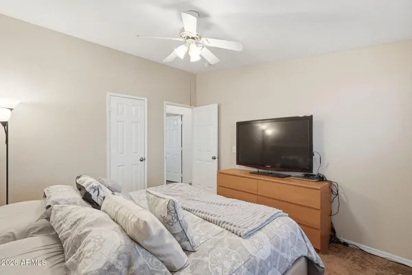 a bedroom with a bed and a flat screen tv