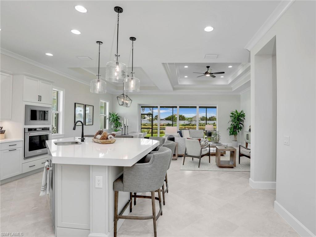 8850 Calypso Court Naples, FL 34113 - Photo 49 of 49 a view of a dining room with furniture window and wooden floor