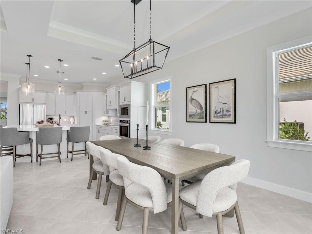 8850 Calypso Court Naples, FL 34113 - Photo 15 of 49 a view of a dining room with furniture