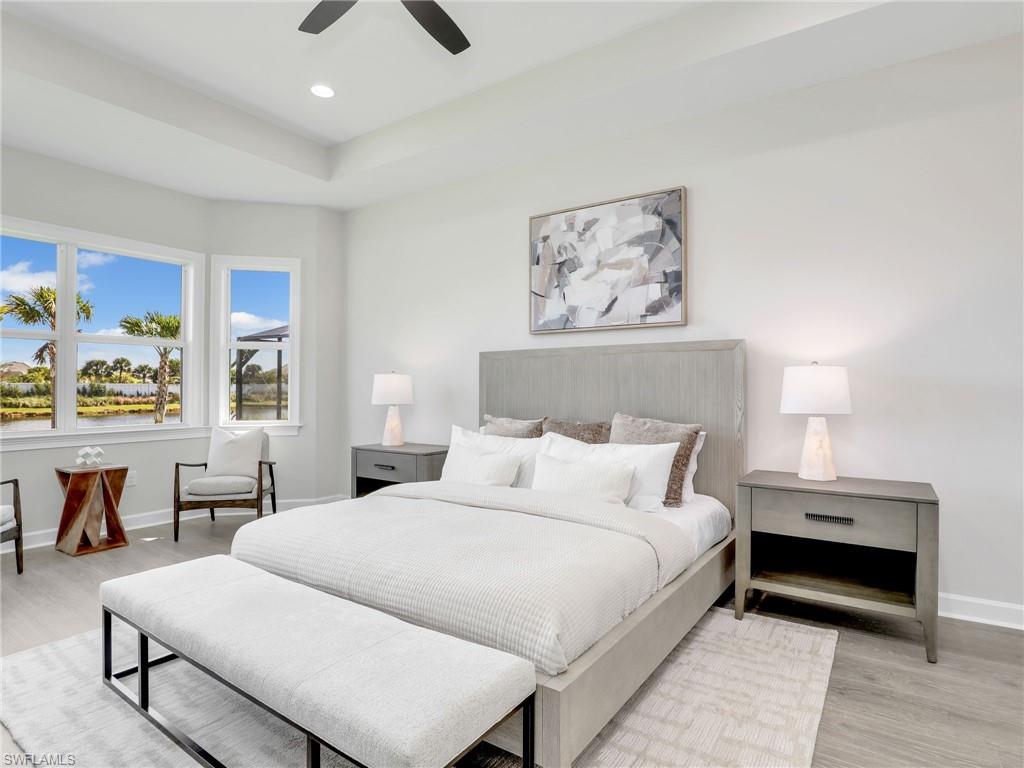 8850 Calypso Court Naples, FL 34113 - Photo 18 of 49 a bedroom with a large bed and a couch