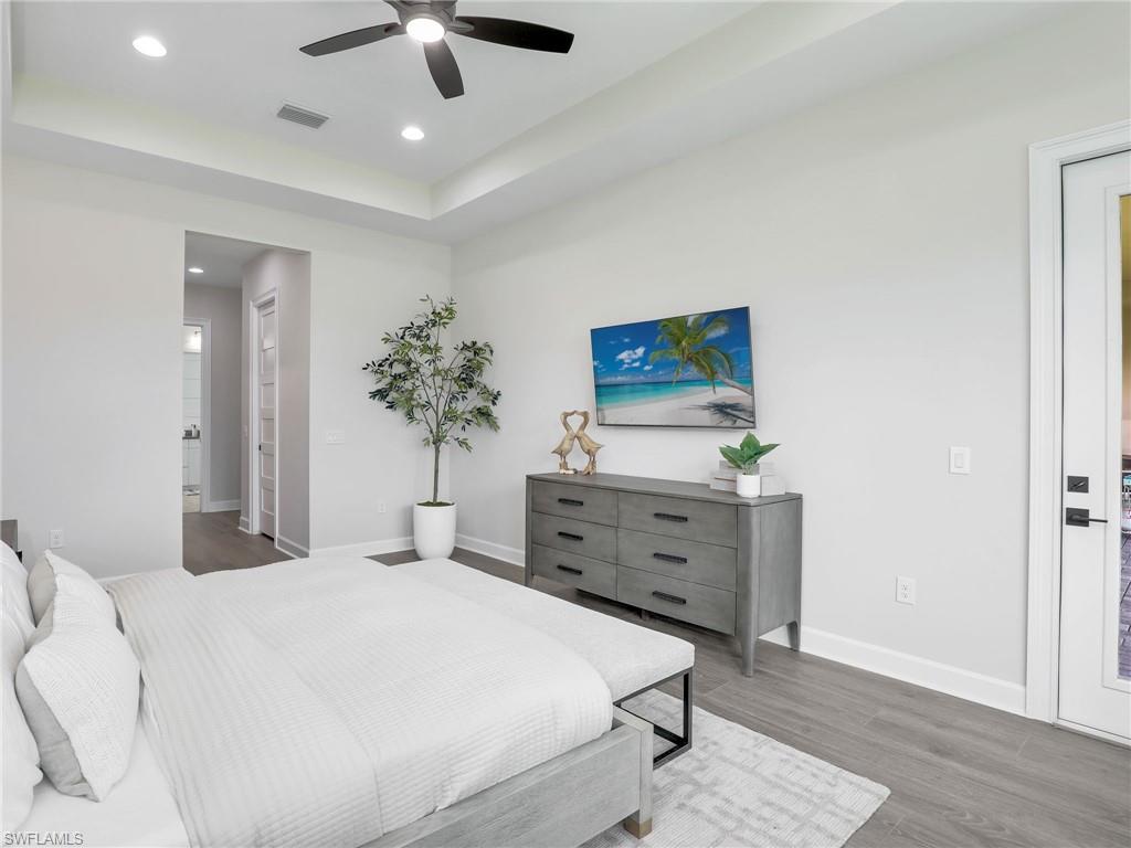8850 Calypso Court Naples, FL 34113 - Photo 19 of 49 a bedroom with a bed and a chandelier