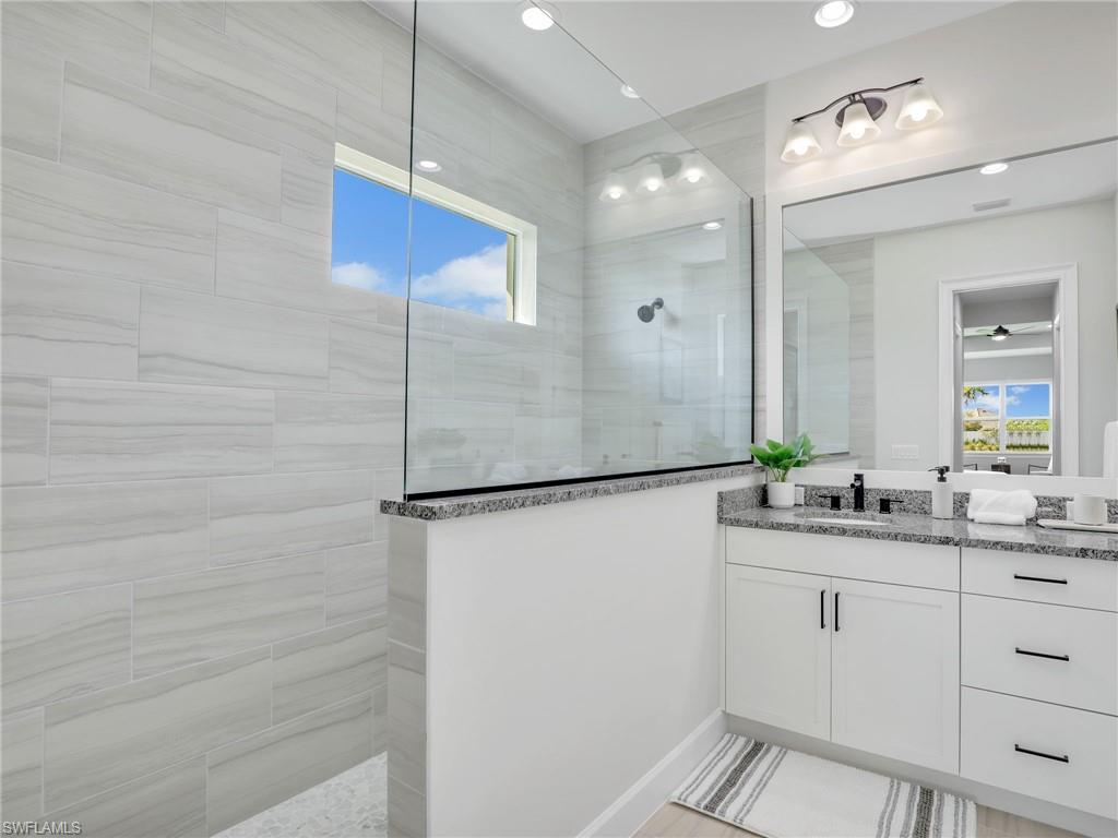 8850 Calypso Court Naples, FL 34113 - Photo 22 of 49 a bathroom with a double vanity sink and mirror