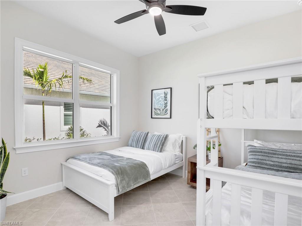 8850 Calypso Court Naples, FL 34113 - Photo 24 of 49 a bedroom with a bed and window