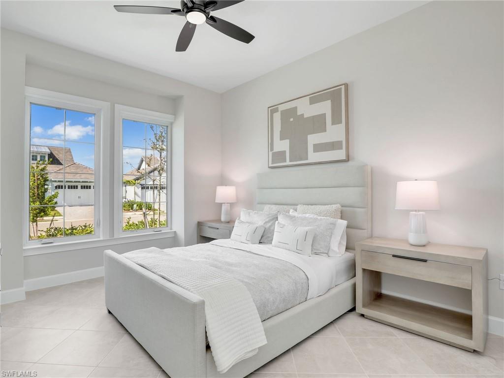 8850 Calypso Court Naples, FL 34113 - Photo 28 of 49 a bedroom with a bed and a painting on the wall