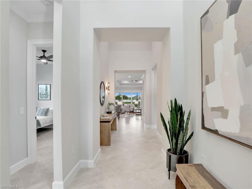 8850 Calypso Court Naples, FL 34113 - Photo 3 of 49 a living room with furniture and a potted plant