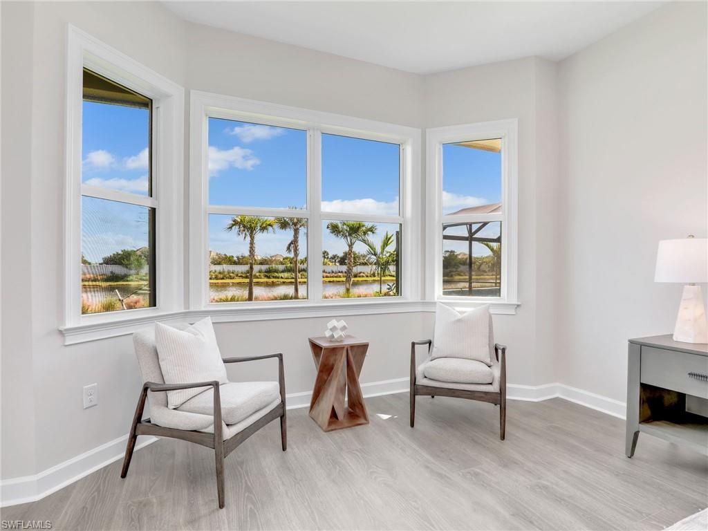 8850 Calypso Court Naples, FL 34113 - Photo 32 of 49 a living room with furniture and a window