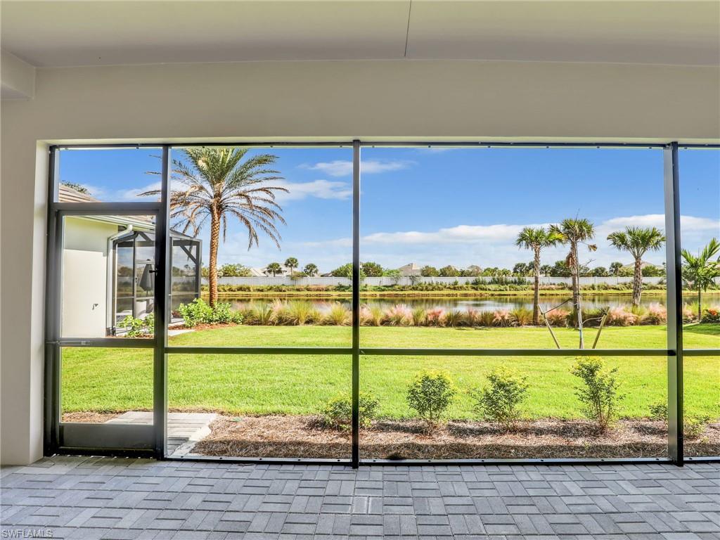 8850 Calypso Court Naples, FL 34113 - Photo 34 of 49 a view of a balcony with floor to ceiling windows yard and ocean view