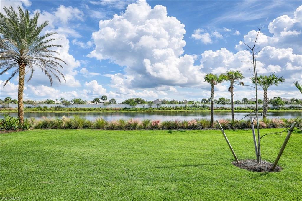 8850 Calypso Court Naples, FL 34113 - Photo 36 of 49 a view of a garden with a lake