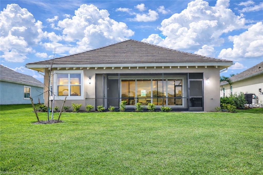 8850 Calypso Court Naples, FL 34113 - Photo 37 of 49 a view of a house with garden and yard