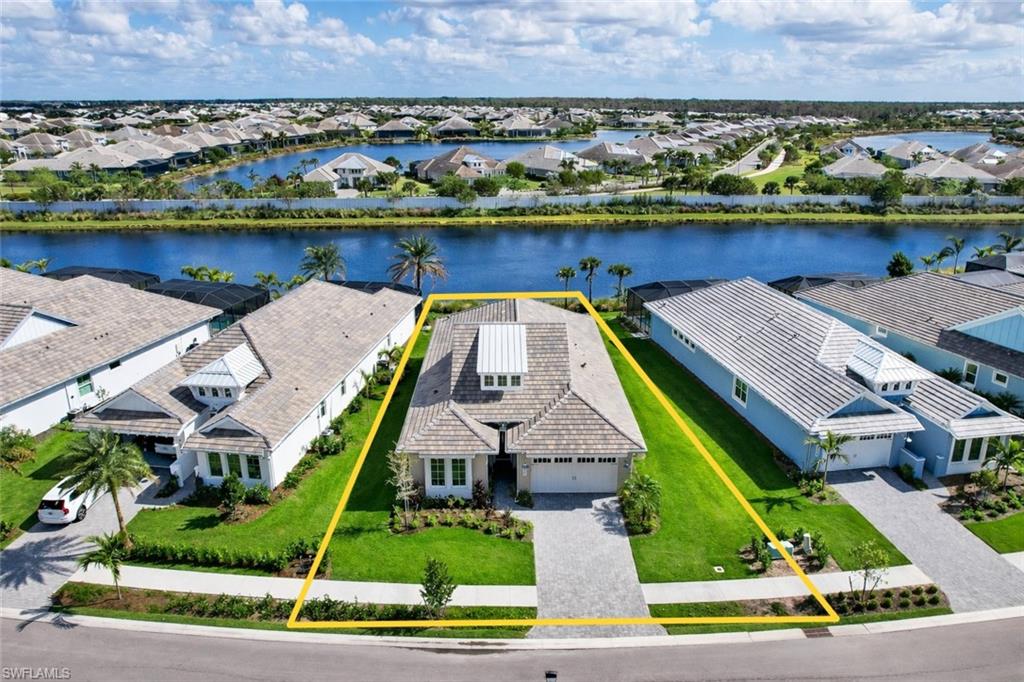 8850 Calypso Court Naples, FL 34113 - Photo 47 of 49 an aerial view of a house with a garden and lake view